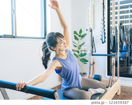 マシンピラティスのトレーニングをする女性 マシンピラティスのトレーニングをする女性 121659387