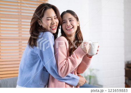 Beautiful two Asian female LGBT lesbian embracing with love and romance , Positive mood and good moment with quality time at warmth place.LGBTQ+ Lifestyle Pride Month 121659883
