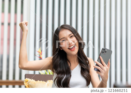Millennial asian young woman looking mobile phone laughing with good news or discount voucher for shopping online at home.Happy and cheerful woman looking on cellphone app read message feel excited Millennial asian young woman looking mobile phone laughing with good news or discount voucher for shopping online at home.Happy and cheerful woman looking on cellphone app read message feel excited 121660251
