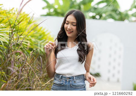 Beautiful asian young woman smile and cheerful. Confident cute female looking at camera relax and happiness with wellness life. good moment and positive emotional. Happy woman enjoy her life concept 121660292