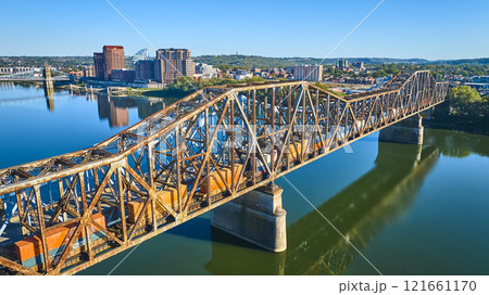 Aerial of Rusted Steel Truss Bridge and Train Over Ohio River at Sunrise Aerial of Rusted Steel Truss Bridge and Train Over Ohio River at Sunrise 121661170