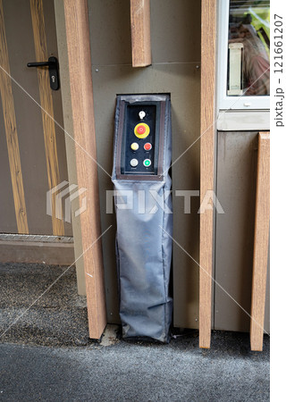Control panel with buttons on the wall, covered with a protective cover. Control panel with buttons on the wall, covered with a protective cover. 121661207