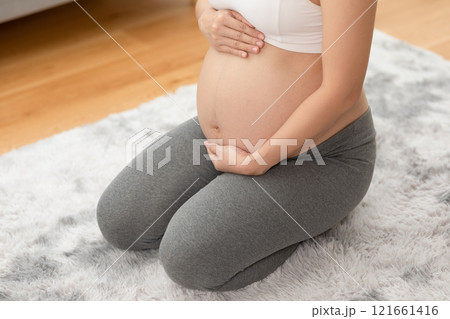 Happy Pregnant Asian Woman sitting on bed holding and stroking her big belly at home,Pregnancy of young woman enjoying with future life relax at home,Motherhood and Pregnant Concept,Soft focus Happy Pregnant Asian Woman sitting on bed holding and stroking her big belly at home,Pregnancy of young woman enjoying with future life relax at home,Motherhood and Pregnant Concept,Soft focus 121661416