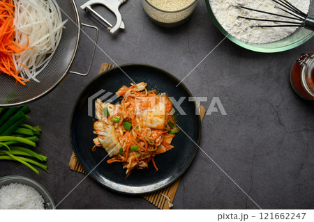 Top view traditional Korean Kimchi served on a plate. Korean cuisine and traditional side dish concept Top view traditional Korean Kimchi served on a plate. Korean cuisine and traditional side dish concept 121662247