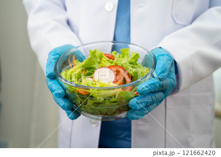 Asian Nutritionist holding healthy food for patient in hospital, nutrition and vitamin. 121662420