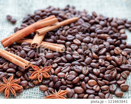 Exploring the rich aromas of roasted coffee beans and spices on a textured surface Exploring the rich aromas of roasted coffee beans and spices on a textured surface 121663841