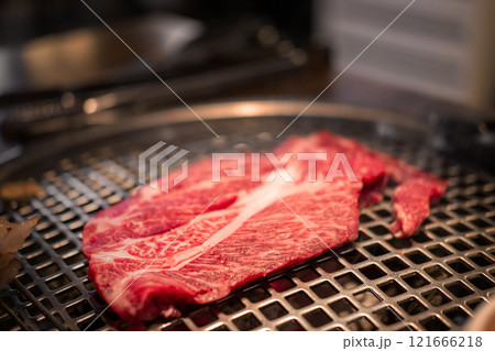 A close-up shot of premium cuts of marbled Hanwoo beef, Korean Style Meat on the Grill. BBQ rare meat with soft focus A close-up shot of premium cuts of marbled Hanwoo beef, Korean Style Meat on the Grill. BBQ rare meat with soft focus 121666218