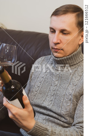 man drinking wine and relaxing 121666512