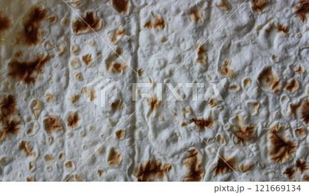 Pattern of sheet of thin pita bread for wrapping meat for shawarma or taco cooking Pattern of sheet of thin pita bread for wrapping meat for shawarma or taco cooking 121669134