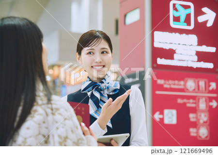 空港でグランドスタッフの案内を受ける女性 121669496