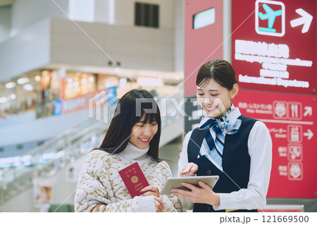 空港でグランドスタッフの案内を受ける女性 121669500