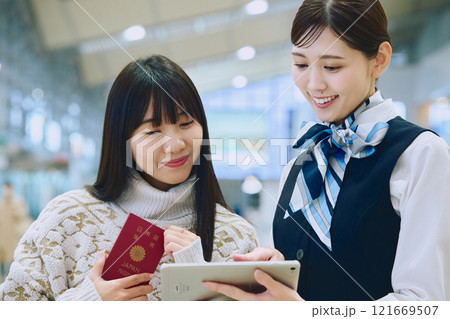 空港でグランドスタッフの案内を受ける女性 121669507