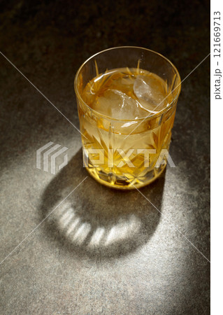 Whiskey with ice in a crystal glass. Whiskey with ice in a crystal glass. 121669713