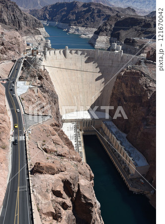 Hoover Dam, Hydroelectric power plant in Clark County, Nevada, industrial construction against the blue sky and mountains 121670042