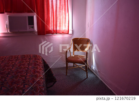 An empty armchair in a room with red light An empty armchair in a room with red light 121670219