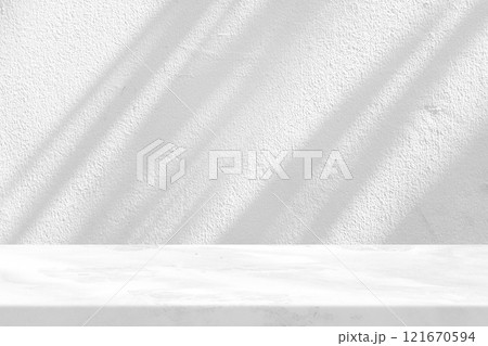 Marble Table with White Stucco Wall Texture Background with Light Beam and Shadow Marble Table with White Stucco Wall Texture Background with Light Beam and Shadow 121670594