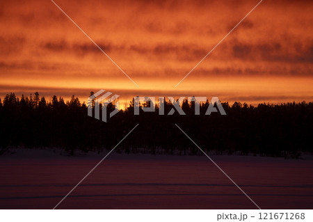 Red sunrise at noon in Lapland Inari Nellin Lake 121671268