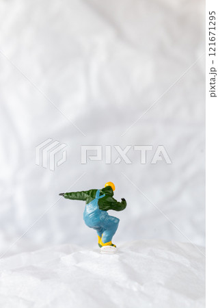Miniature people  snowboarder dressed in vibrant winter gear, carving through a snowy slope 121671295
