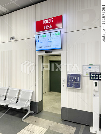 Scoreboard in front of entrance to the toilet at airport. Technology and public spaces in city. Information about availability of free seats. 121672061