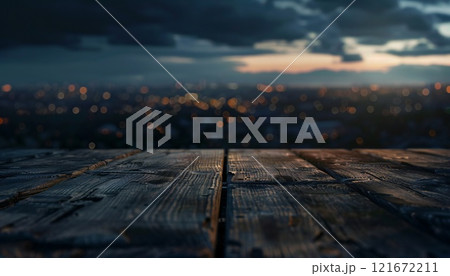 A wooden table rests in the twilight, with a blurred cityscape visible in the background 121672211