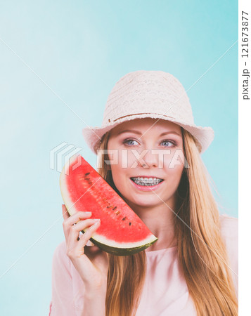 Happy woman holding watermelon Happy woman holding watermelon 121673877