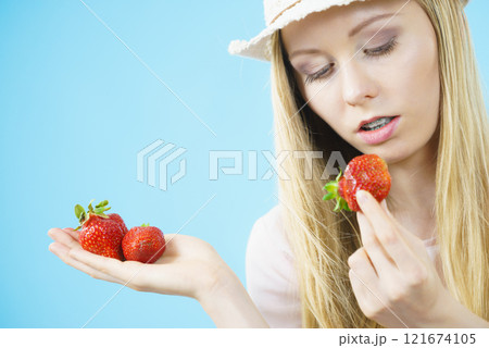 Young woman with fresh strawberries Young woman with fresh strawberries 121674105