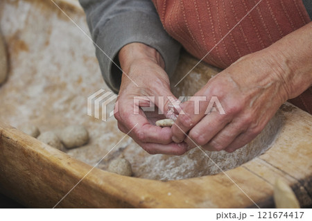 An elderly woman prepares food at a Viking festival in Denmark An elderly woman prepares food at a Viking festival in Denmark 121674417