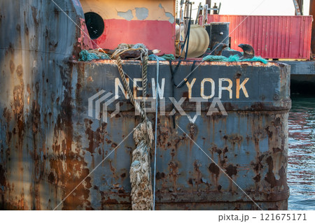 Old rusty barge ladder moored in New York City 121675171