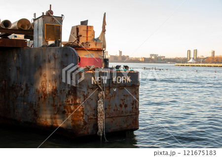 Old rusty barge ladder moored in New York City 121675183