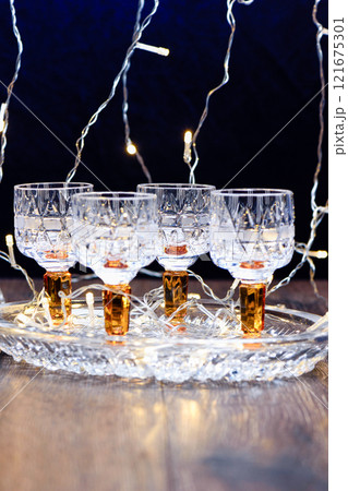 Crystal tray with crystal glasses and garland lighting. Crystal tray with crystal glasses and garland lighting. 121675301