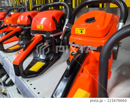 Exploring the vibrant array of chainsaws in a home improvement store display 121676660