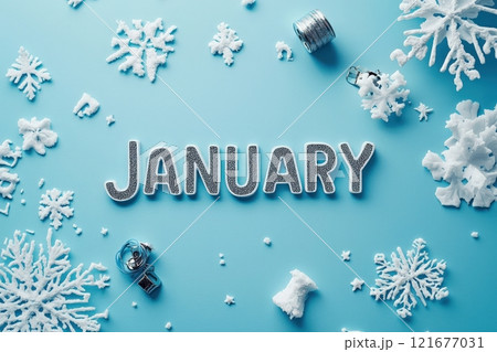 The word January is displayed prominently in shiny, glittery letters on a light blue surface. 121677031