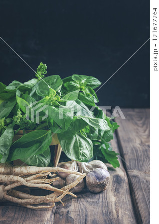 Basil, parsley, garlic. Fragrant herbs. Ingredient for vegetarian salads, soups, sauces. Fresh greens. Harvest. Spices. Basil, parsley, garlic. Fragrant herbs. Ingredient for vegetarian salads, soups, sauces. Fresh greens. Harvest. Spices. 121677264