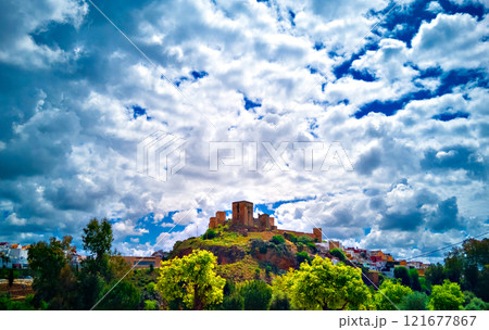Views from the Parque de la Retama of the castle of Alcala de Guadaira in Seville, in blue sky and white clouds Views from the Parque de la Retama of the castle of Alcala de Guadaira in Seville, in blue sky and white clouds 121677867