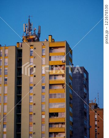 Cellular antennas and transmitters on roof of residential building. Radio transmitting equipment and communication lines on roof. 5G antennas. Evening sunset sky. Pula, Croatia - January 3, 2025 121678530