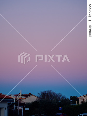 Beautiful color transitions in the sky at dusk after sunset. Natural beauty in nature. Landscape with roofs of city houses. Natural gradient background. Pula, Croatia - January 3, 2025 Beautiful color transitions in the sky at dusk after sunset. Natural beauty in nature. Landscape with roofs of city houses. Natural gradient background. Pula, Croatia - January 3, 2025 121678559