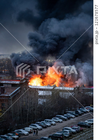 Heavy fire with acrid smoke in warehouse with toxic paint materials. Industrial fire, air pollution. Heavy fire with acrid smoke in warehouse with toxic paint materials. Industrial fire, air pollution. 121678577
