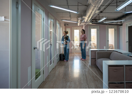 Woman farewell, hugs cat before leaving in professional pet hotel for quality temporary care service 121678610