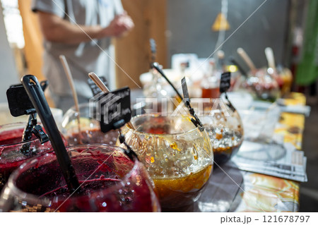 Bowls of sweet jams, fruit preserves displayed on stall at local fair, small business food products Bowls of sweet jams, fruit preserves displayed on stall at local fair, small business food products 121678797