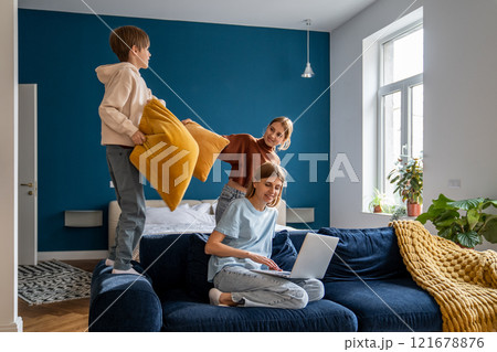 Young woman mother freelancer combining remote work with spending more time with family Young woman mother freelancer combining remote work with spending more time with family 121678876