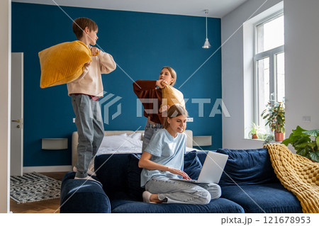 Young woman mother freelancer combining remote work with spending more time with family Young woman mother freelancer combining remote work with spending more time with family 121678953
