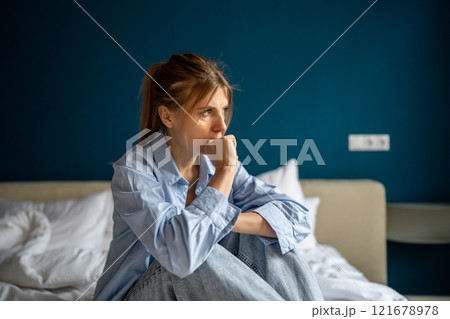 Depressed stressed middle age woman sit biting fingers with nervous breakdown after emotional trauma 121678978
