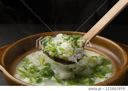 七草粥　土鍋で炊いた七草がゆを茶碗に盛り付ける　 121681958