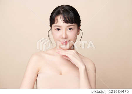 Beautiful young asian woman with clean fresh skin on beige background, Face care, Facial treatment, Cosmetology, beauty and spa, Asian women portrait. 121684479