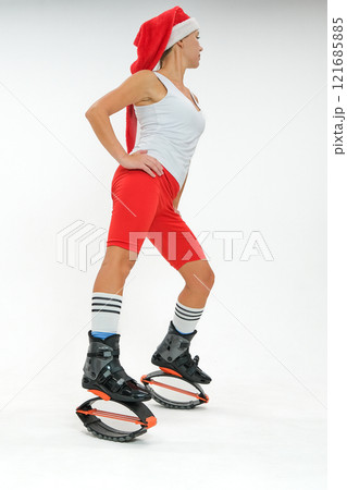 Girl in a New Year's hat and Stylish kangoo shoes 121685885