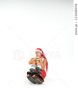 Girl in a New Year's hat and Stylish kangoo shoes 121686039
