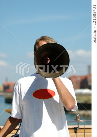 Man speaking in a megaphone 121688431