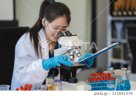 Female biotechnologist testing new chemical substances in a laboratory. Female biotechnologist testing new chemical substances in a laboratory. 121691379