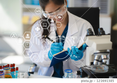 Female biotechnologist testing new chemical substances in a laboratory. 121691385