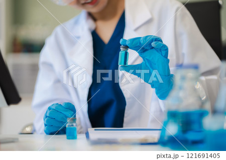 Female biotechnologist testing new chemical substances in a laboratory. Female biotechnologist testing new chemical substances in a laboratory. 121691405